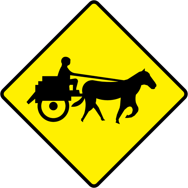 A triangular warning traffic sign in Ireland depicting jaunting cars. Memorize for DTT.