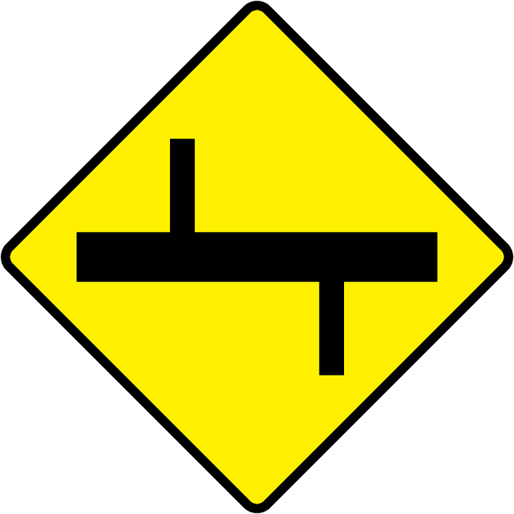 A triangular warning traffic sign in Ireland depicting staggered crossroads ahead - left. Memorize for DTT.