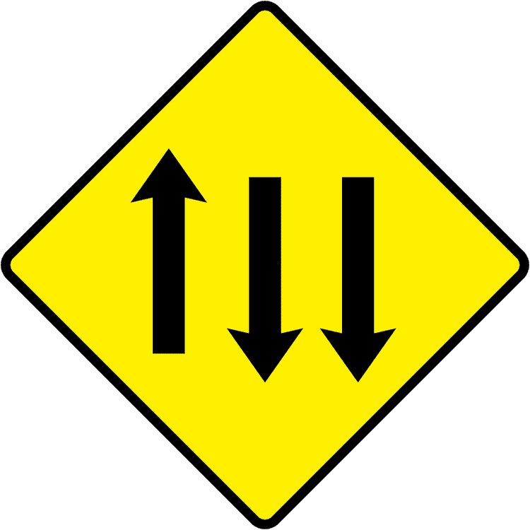 A triangular warning traffic sign in Ireland depicting three lanes of traffic (one with, two against). Memorize for DTT.