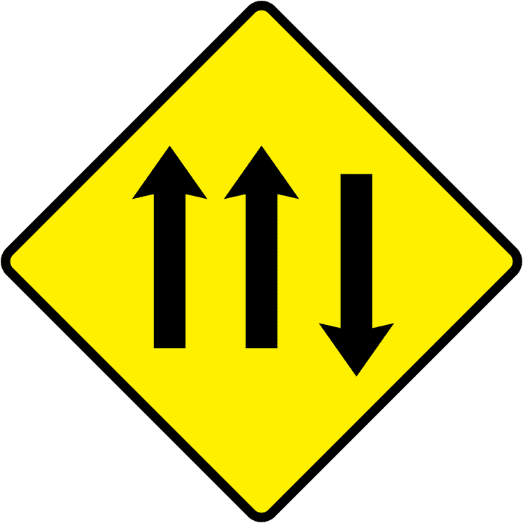 A triangular warning traffic sign in Ireland depicting three lanes of traffic (two with, one against). Memorize for DTT.