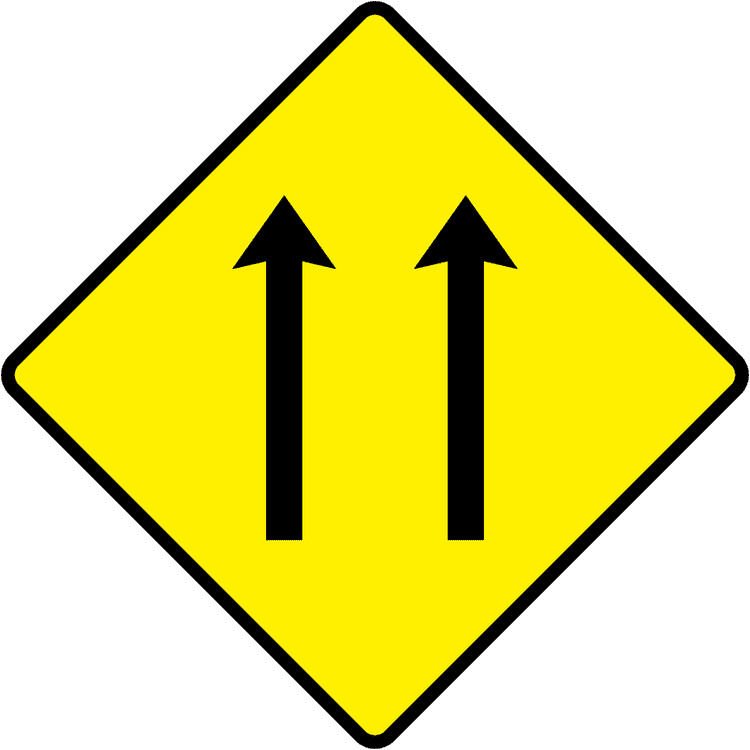 A triangular warning traffic sign in Ireland depicting two-lane section. Memorize for DTT.